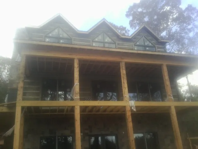 Dormers and porch framing on a large log home under construction in Seattle